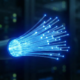 Close-up of glowing blue fiber optic strands representing high-speed data transmission